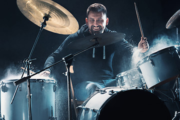 Image showing Drummer rehearsing on drums before rock concert. Man recording music on drum set in studio