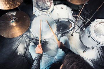 Image showing Drummer rehearsing on drums before rock concert. Man recording music on drum set in studio