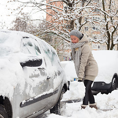 Image showing Independent woman shoveling snow in winter.