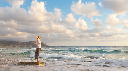 Image showing Free Happy Woman Enjoying Sunset on Sandy Beach