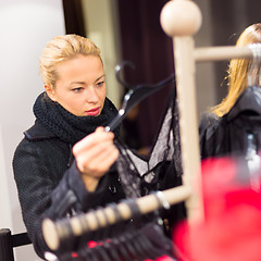 Image showing Beautiful woman shopping in clothing store.