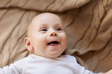 Image showing sweet little baby boy lying on knitted blanket