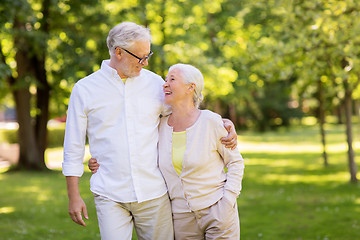 Image showing happy senior couple hugging at summer park