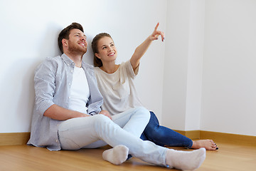 Image showing happy couple at empty room of new home