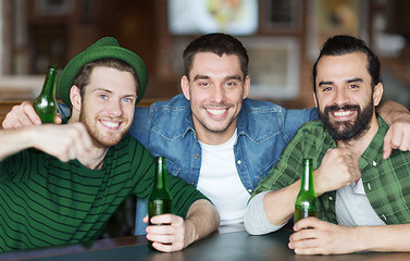 Image showing happy male friends drinking beer at bar or pub