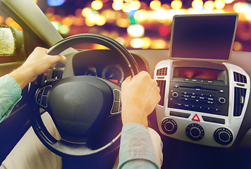 Image showing close up of young man with tablet pc driving car