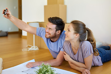 Image showing couple taking selfie and moving to new home