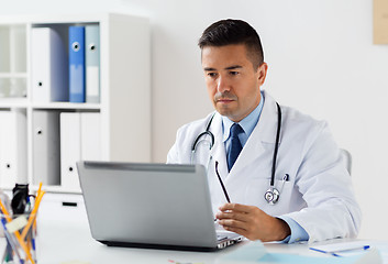 Image showing male doctor in white coat with laptop at hospital