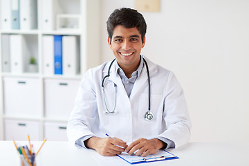 Image showing happy doctor with clipboard at clinic