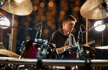 Image showing male musician playing drum kit at concert