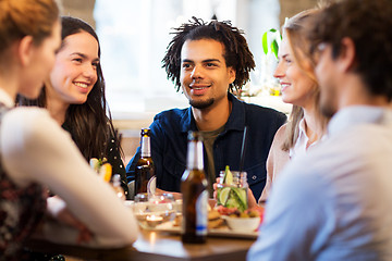Image showing happy friends eating at bar or restaurant