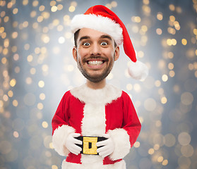 Image showing man in santa claus costume over christmas lights