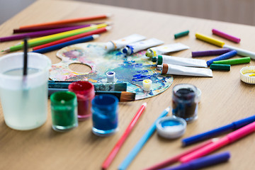 Image showing palette, brushes and paint tubes on table