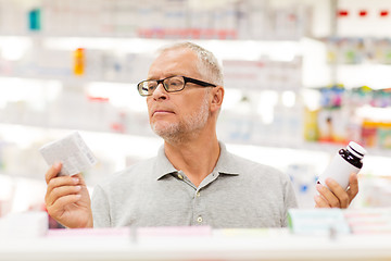 Image showing senior male customer choosing drugs at pharmacy