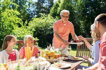 Image showing family having dinner or barbecue at summer garden