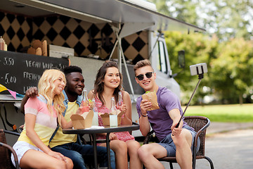 Image showing happy young friends taking selfie at food truck