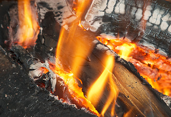 Image showing Texture of burning open fireplace with fire, flame, wood and embers