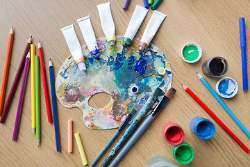 Image showing color palette, brushes and paint tubes on table