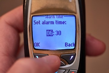 Image showing Setting alarm on old cellphone
