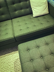 Image showing Comfortable green sofa with foot stool