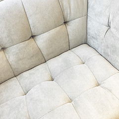 Image showing Corner of a shiny white velvet sofa