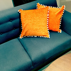 Image showing Fancy orange cushions decorating a sofa