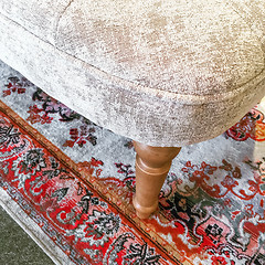 Image showing Detail of a luxurious armchair on a classic rug