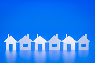 Image showing a paper cutout row of houses blue background