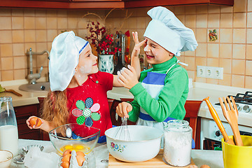 Image showing happy family funny kids are preparing the dough, bake cookies in the kitchen