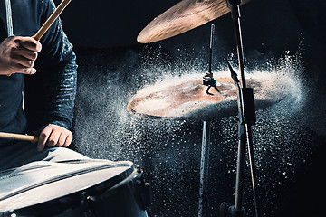 Image showing Drummer rehearsing on drums before rock concert. Man recording music on drum set in studio