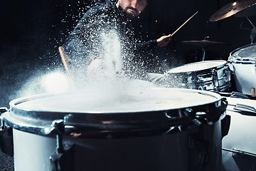 Image showing Drummer rehearsing on drums before rock concert. Man recording music on drum set in studio