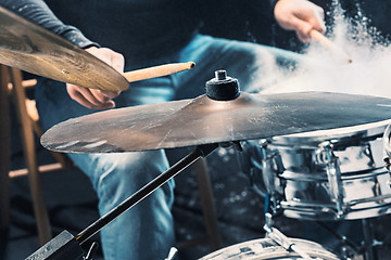 Image showing Drummer rehearsing on drums before rock concert. Man recording music on drum set in studio