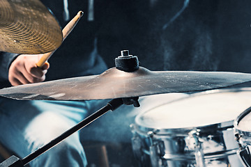 Image showing Drummer rehearsing on drums before rock concert. Man recording music on drum set in studio