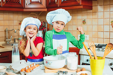 Image showing happy family funny kids are preparing the dough, bake cookies in the kitchen