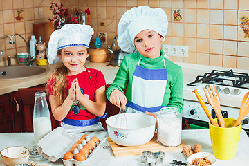 Image showing happy family funny kids are preparing the dough, bake cookies in the kitchen