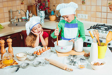 Image showing happy family funny kids are preparing the dough, bake cookies in the kitchen