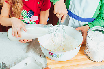 Image showing happy family funny kids are preparing the dough, bake cookies in the kitchen