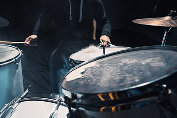 Image showing Drummer rehearsing on drums before rock concert. Man recording music on drum set in studio