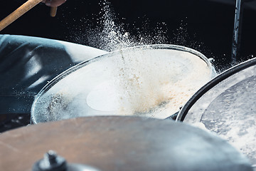 Image showing Drummer rehearsing on drums before rock concert. Man recording music on drum set in studio