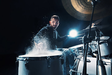 Image showing Drummer rehearsing on drums before rock concert. Man recording music on drum set in studio