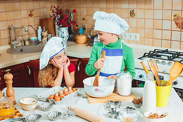 Image showing happy family funny kids are preparing the dough, bake cookies in the kitchen