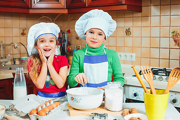 Image showing happy family funny kids are preparing the dough, bake cookies in the kitchen