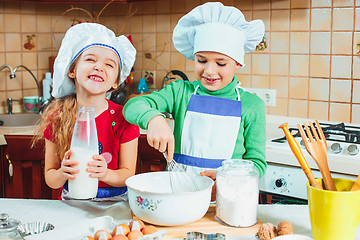 Image showing happy family funny kids are preparing the dough, bake cookies in the kitchen