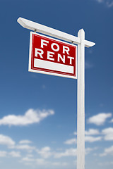 Image showing Left Facing For Rent Real Estate Sign on a Blue Sky with Clouds.