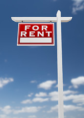 Image showing Left Facing For Rent Real Estate Sign on a Blue Sky with Clouds.