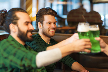 Image showing male friends drinking green beer at bar or pub