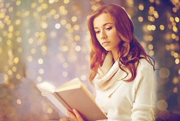 Image showing young woman reading book at home