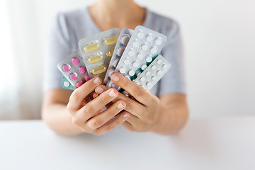 Image showing woman hands holding packs of pills