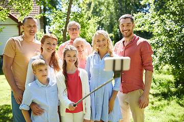 Image showing happy family taking selfie in summer garden