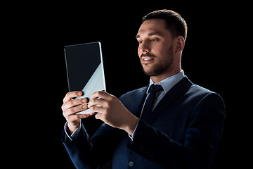 Image showing businessman in suit with transparent tablet pc